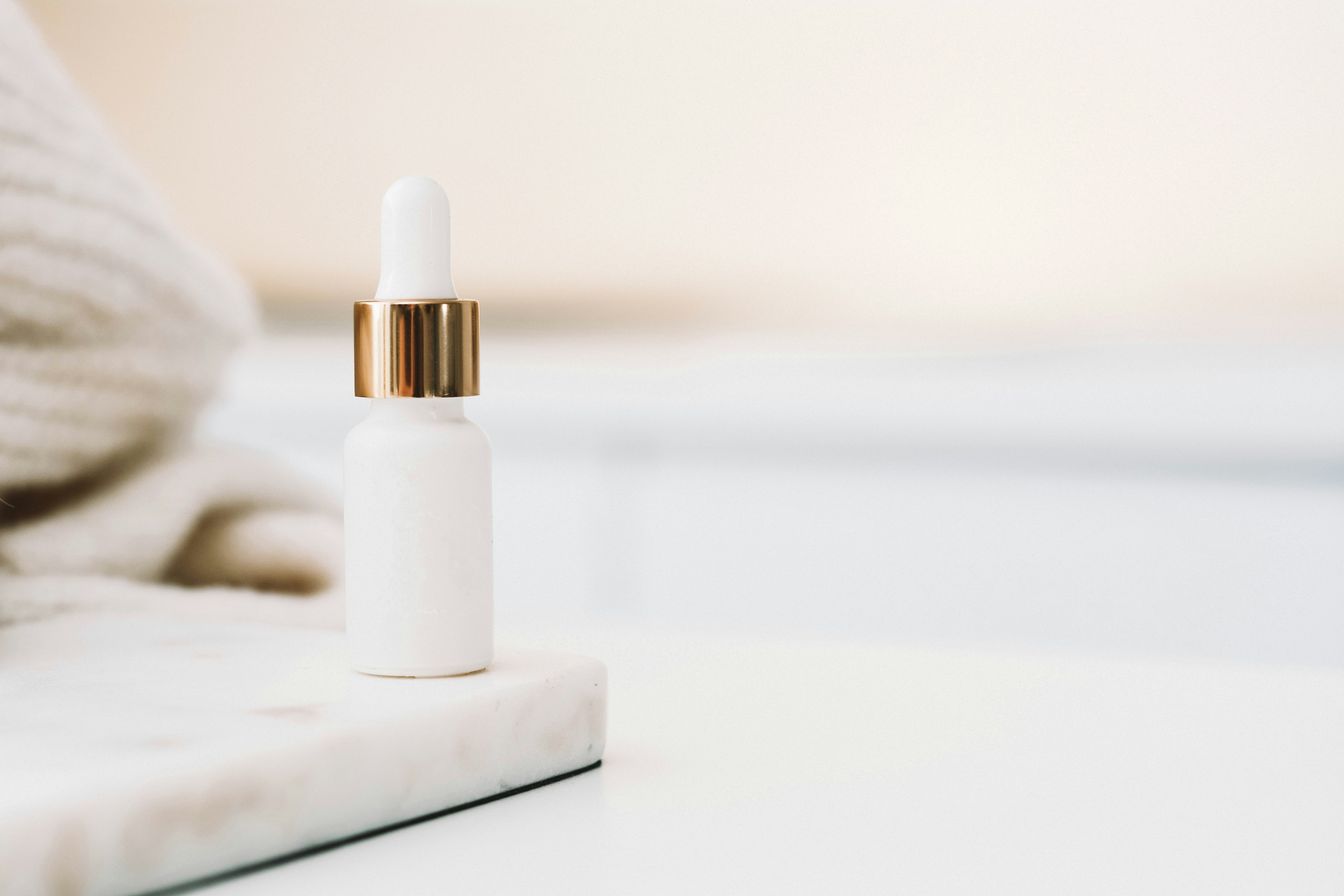 A skincare bottle on top of a bathroom counter.