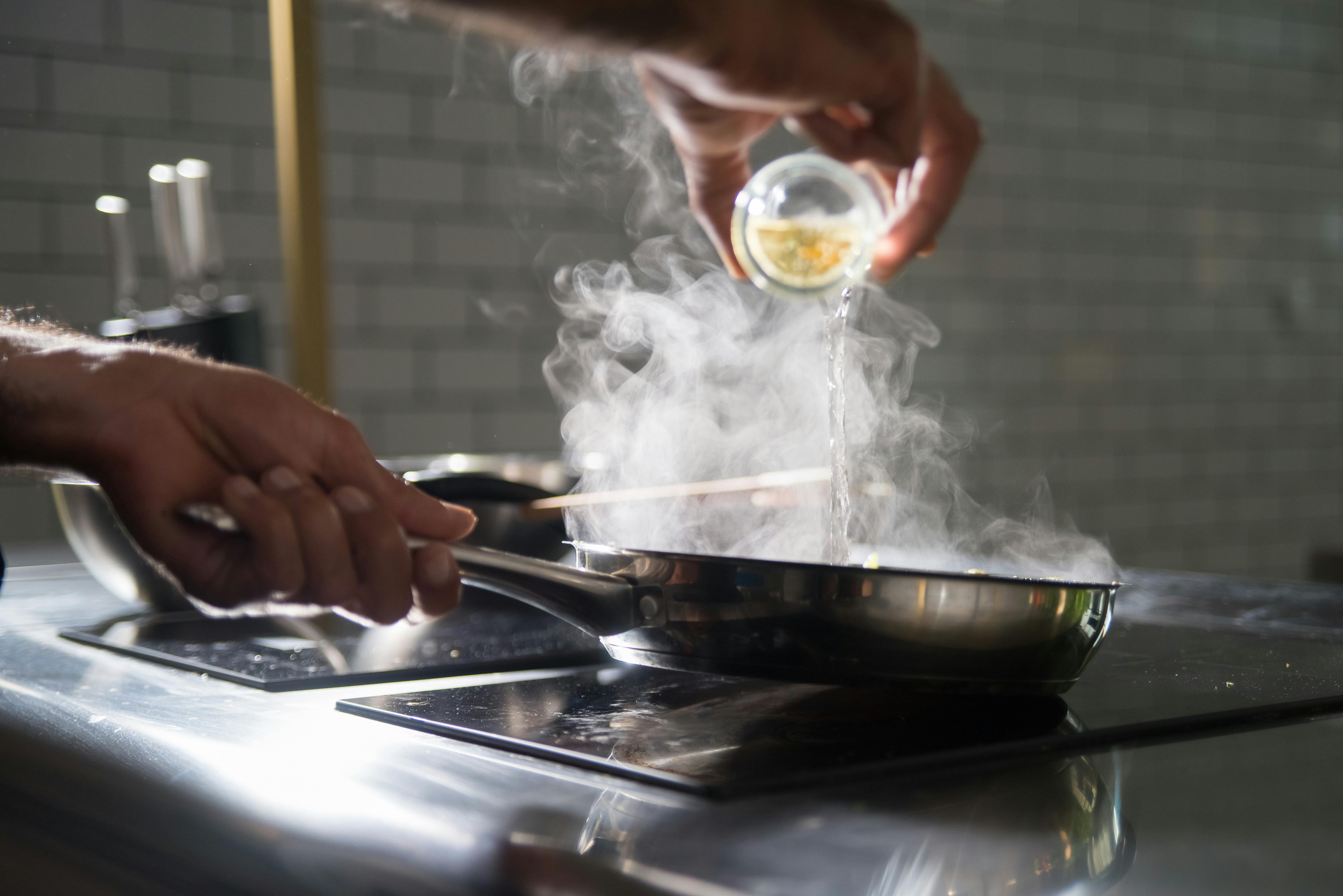 A gleaming, high-quality stainless steel pan on a clean kitchen counter.